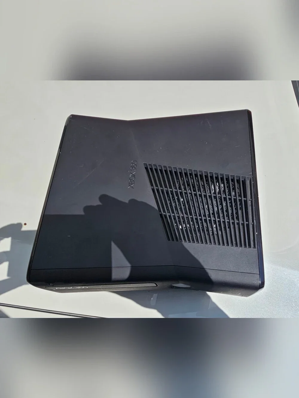 Microsoft Xbox 360 S (Slim) console, featuring a sleek black